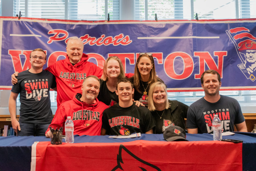 Senior Jordan Kelly celebrates signing to the University of Louisville swimming with his family.