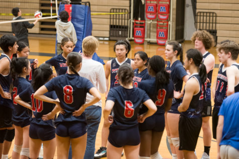 Co-ed volleyball huddles around coach Mary Malinauskas during the BCC quarter final.