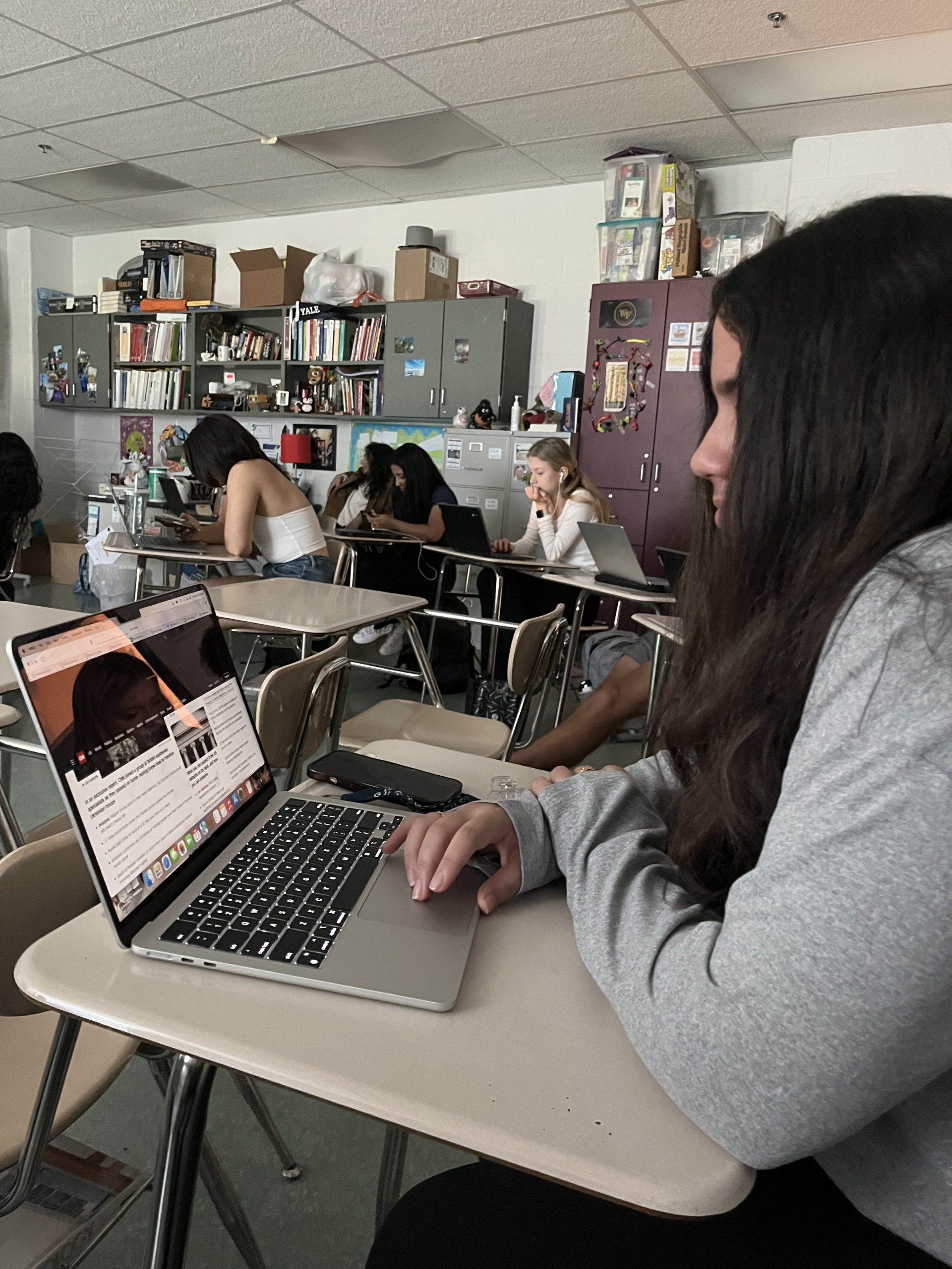 Junior Ayesha Gulati reads the news during advisory.