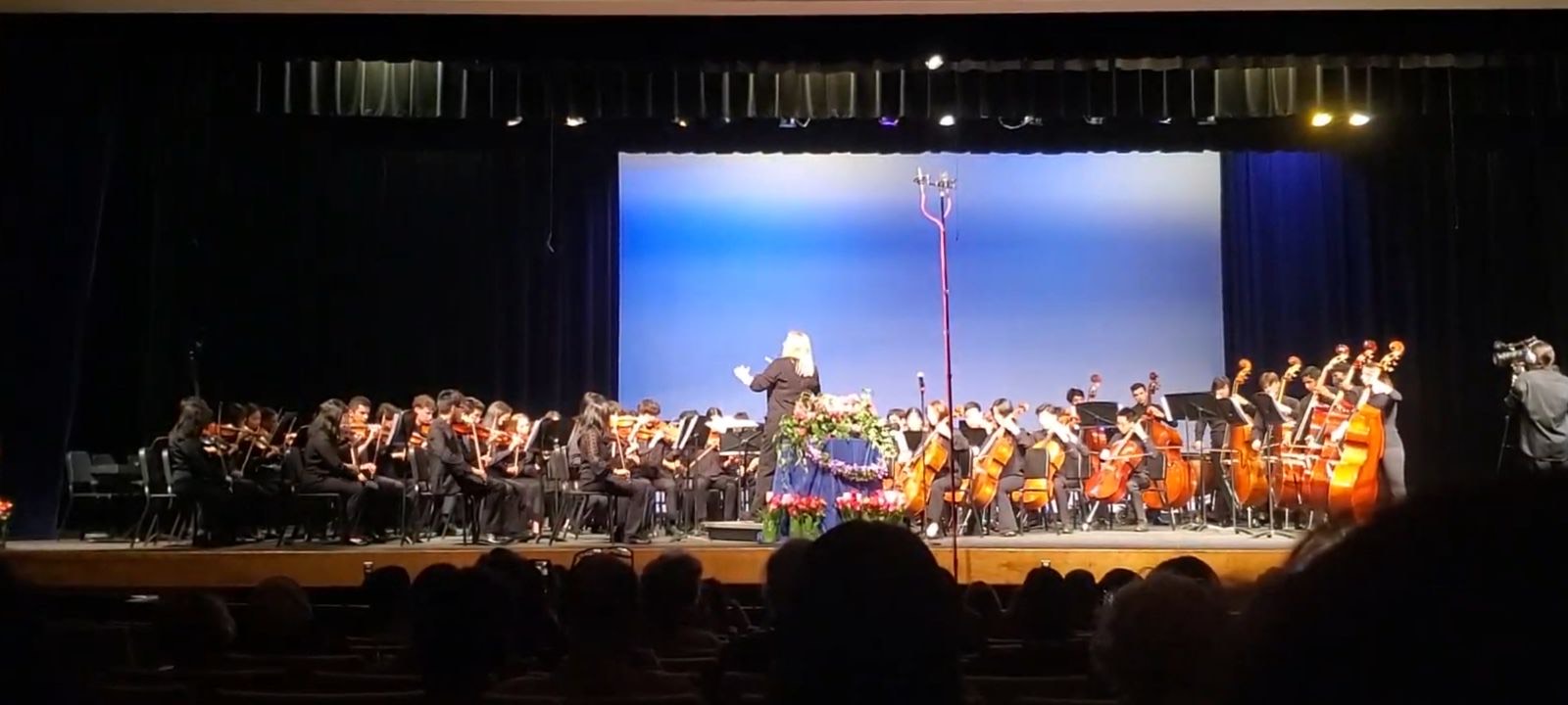 Music teacher Carolyn Herman conducts the orchestra as they play during the spring concert.
