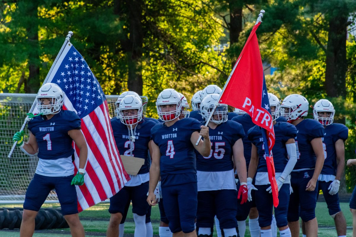 Seniors+Mathew+Repie+and+Daniel+Kim+prepare+to+lead+the+varsity+football+team+onto+the+field+on+Sept.+1+against+Poolesville.+The+team+goes+on+to+win+this+game%2C+giving+hope+about+the+football+teams+season.