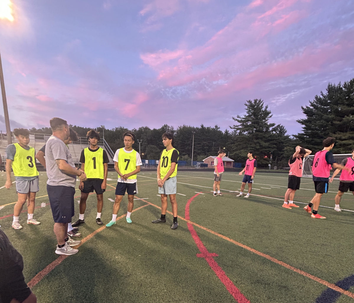 Head Coach Eric Cava addresses his players during a Tuesday night practice in September.