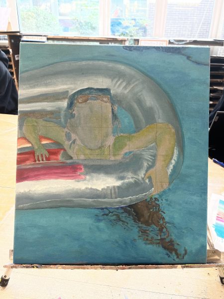 Senior Naomi Esterowitz is painting an acrylic portrait of her younger self for her sustained investigation in AP Drawing.