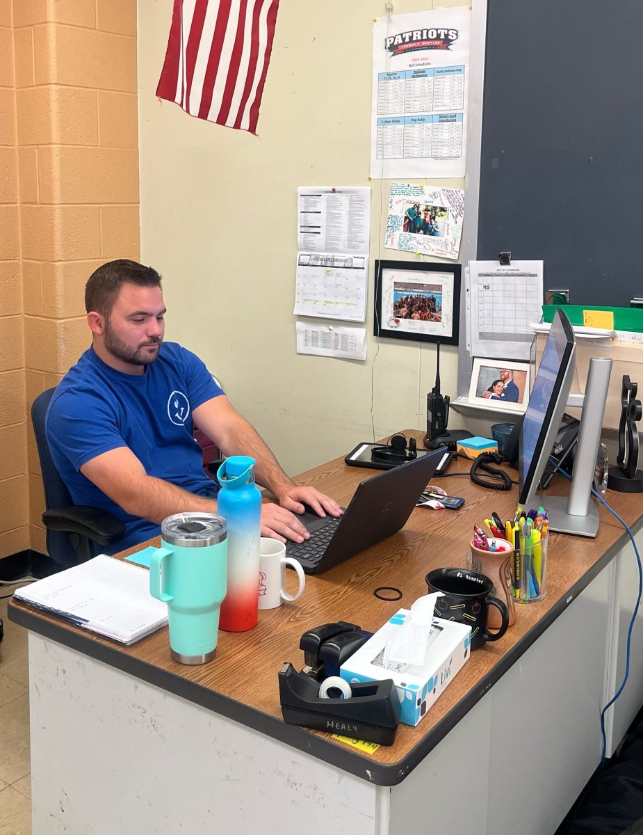 Paraeducator and football and wrestling coach Shane Bramble reviews the wrestling roster for the upcoming season.
