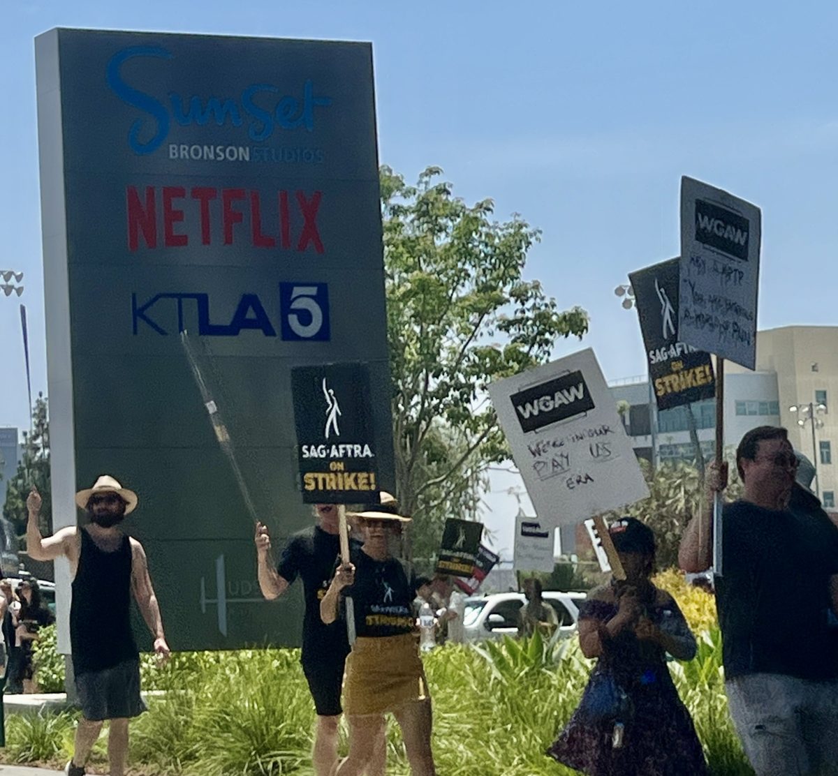 Actors striking outside of film studios demand fair wages.