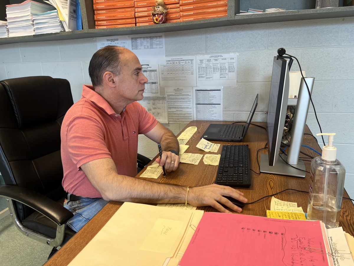 Spanish teacher Matthew Salzman reviews grades during advisory.