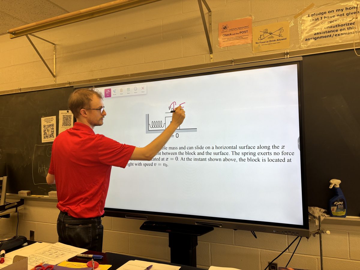 Science teacher Gavin Kramar reviews advanced AP Physics 1 concepts during advisory on Nov. 17.