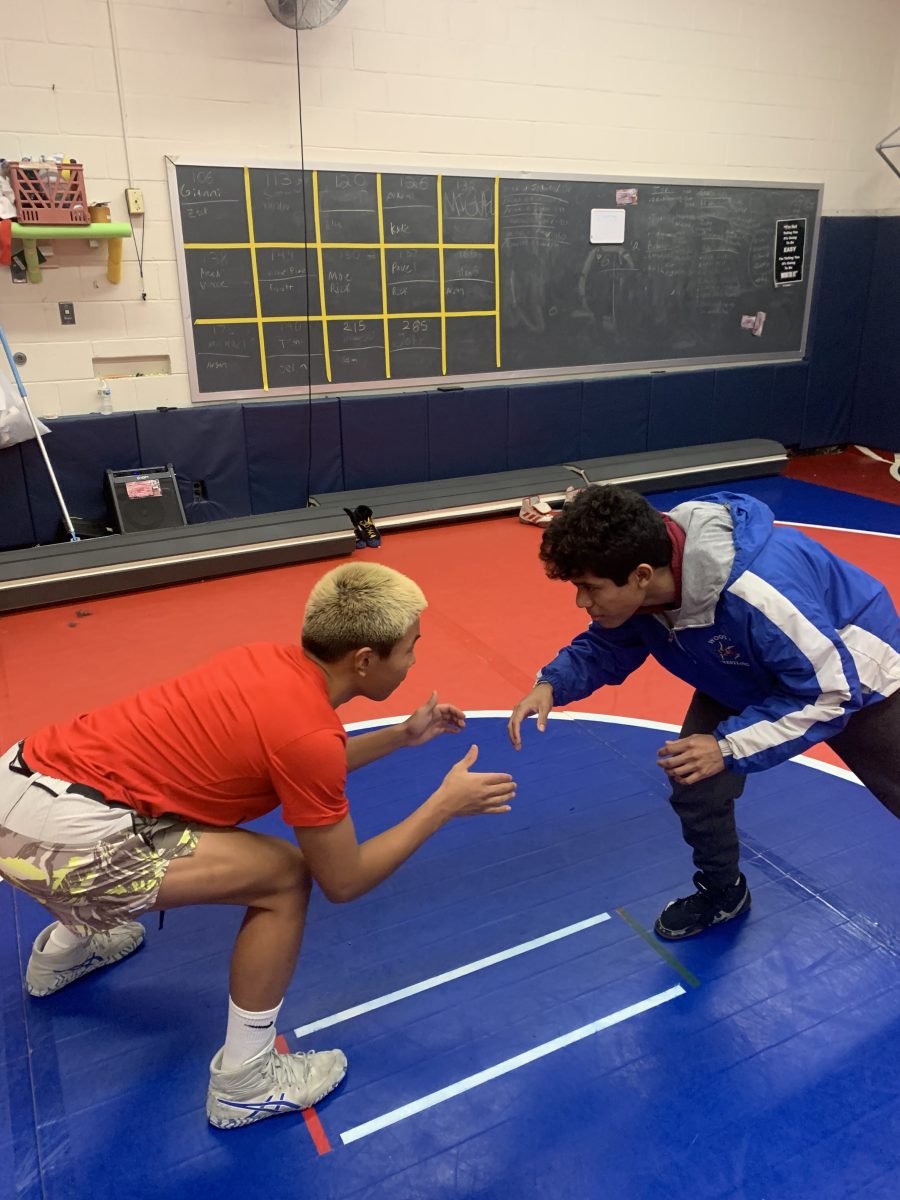 Juniors Miguel Giron Uriarte and Argil Bilegsaikhan warm up for wrestling practice.