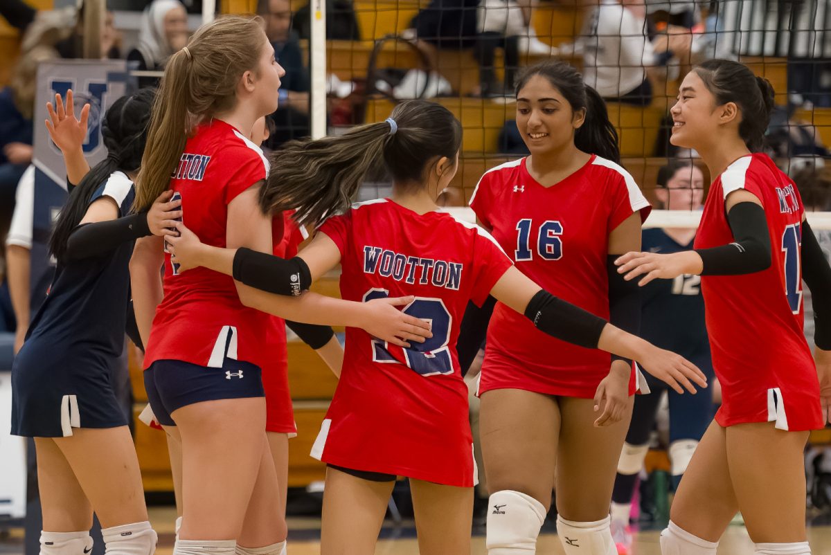 Sophomore+Nishikaa+Poona+embraces+her+teammates+at+a+game+vs.+Urbana+on+Oct.+18.