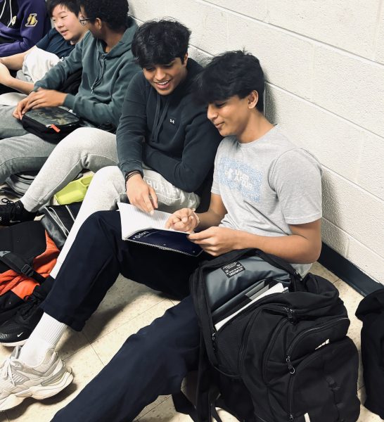Sophomores Jay Vardhan and Vishnu Varma begin mapping out their study schedules for their AP exams in the hallway. It’s good to stay prepared so that we do well in May, Vardhan said. AP tests take place in early May.