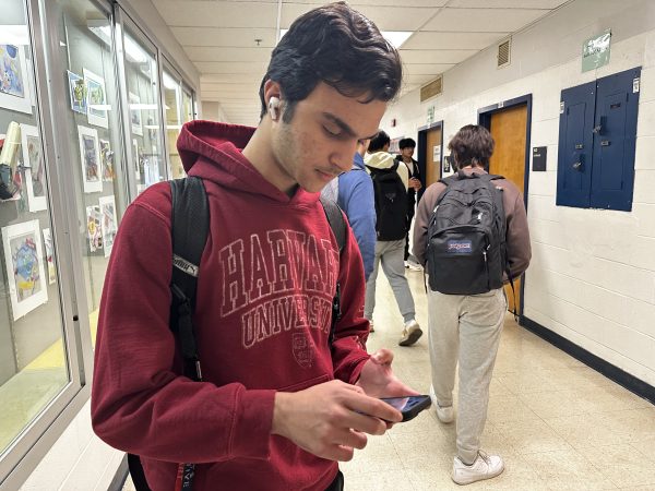 Junior Ehsan Yousefi watches Iran vs. Japan in the AFC Asian Cup on his phone during school. This semifinal game will determine the fate of Yousefi’s team, Iran, in the tournament. “Iran dominated the second half of the game,” Yousefi said.