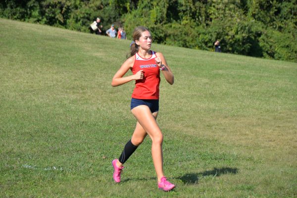 Junior Eva Veizis runs a cross-country home meet versus Walter Johnson on Sep. 20. Vaizis is a top 10 runner for the girls and is finishing her last lap on one of the first races of the season. “I enjoy running because it helps relieve me from stress,” Vaizis said.
