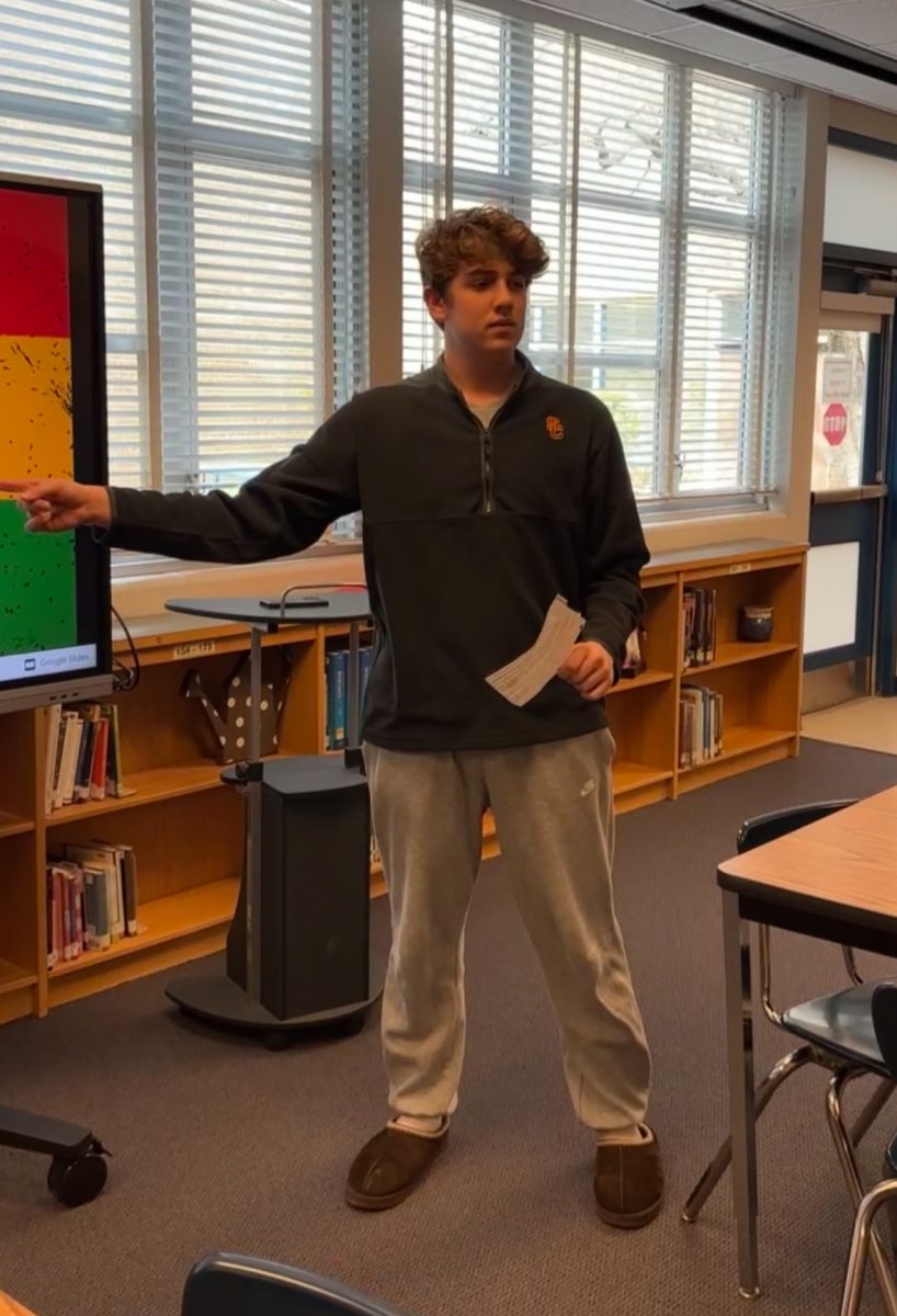 Junior Max Greenberg practices for his team multimedia project (TMP) presentation in the Media Center. AP Seminar students work diligently to perfect their presentations.
