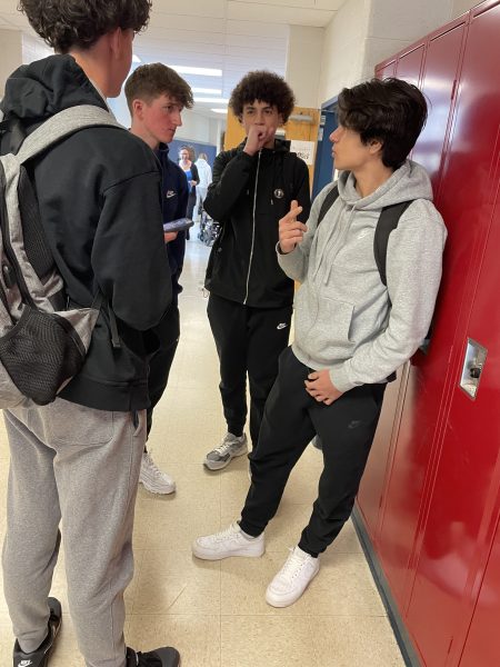 Freshman Haim Mikowski, and sophomores Nathan Downie, Jibril Arezki and Erik Nersesian discuss semester schedule changes in the language hallway during lunch on Feb. 15. Were all frustrated about the schedule changes, but were trying to make the most of them with some jokes, Mikowski said.
