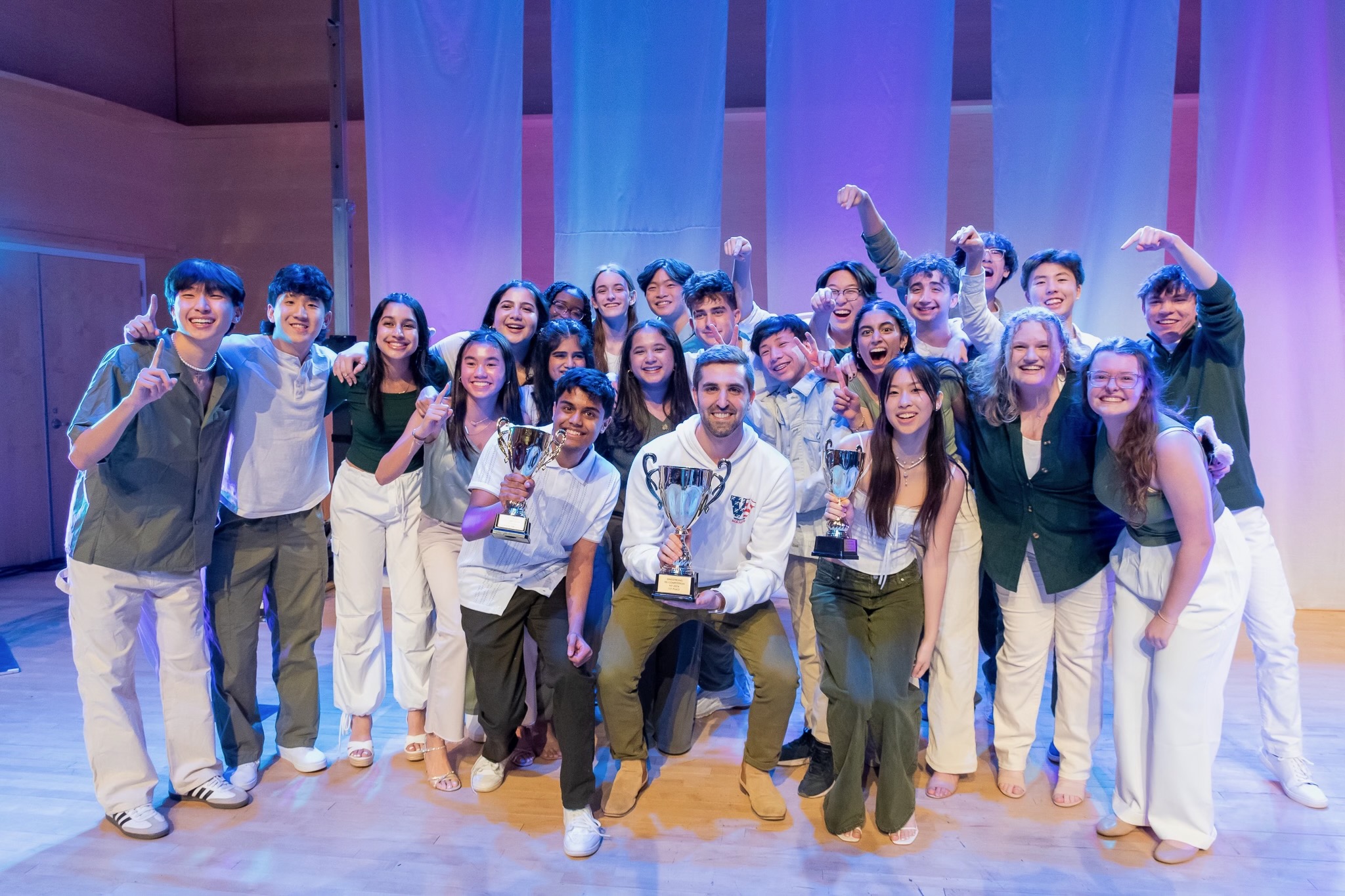 The Acatonics hold up their three trophies after winning first place at Sing Strong NY on Feb. 3, winning First Place Overall, Best Soloist (Ashley Chan) and Best Vocal Percussionist (Shravan Kannepalli).