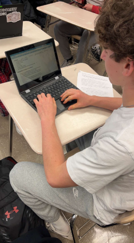 Sophomore Justin Heller reads the College Board website on digital AP exams. Heller took AP Computer Science his freshman year and the exam was digital. This year he is taking AP Government and Politics and the exam is on paper. “I think that digital exams are a lot easier and less work,” Heller said.