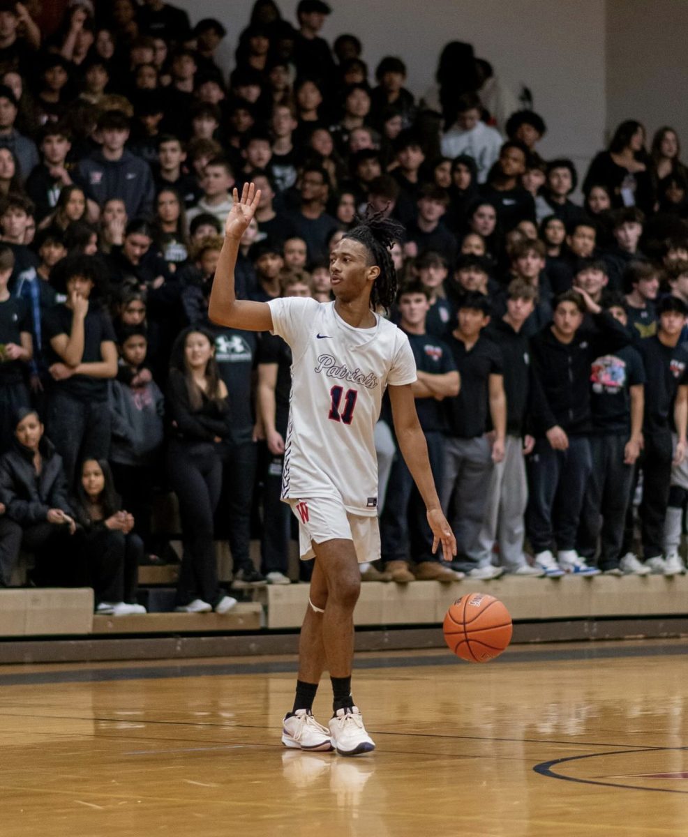 Junior Khairi Hyde plays in the first of the boys basketball games vs Churchill on Dec. 20. This game ended in a close Patriot loss, which the team avenged on Feb. 5 with a win.
