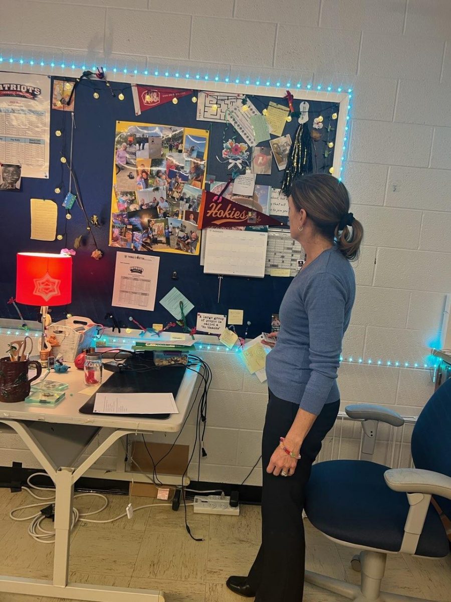 AP Psychology, sociology and leadership teacher Amy Buckingham turns on the LED lights in her classroom at the beginning of her seventh period sociology class on Feb. 27. For me, the value comes in not only expressing my own interests, but opening doors to connect with my students and creating a space in which they all feel comfortable, which opens a door in a more thoughtful student discourse, Buckingham said.