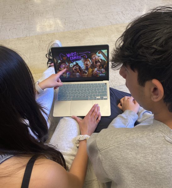 Freshmen Nikhil Arya and Olivia Duong sit in the auditorium lobby during lunch watching the trailer to one of Duongs favorite movies, The Mitchells vs. The Machines.
