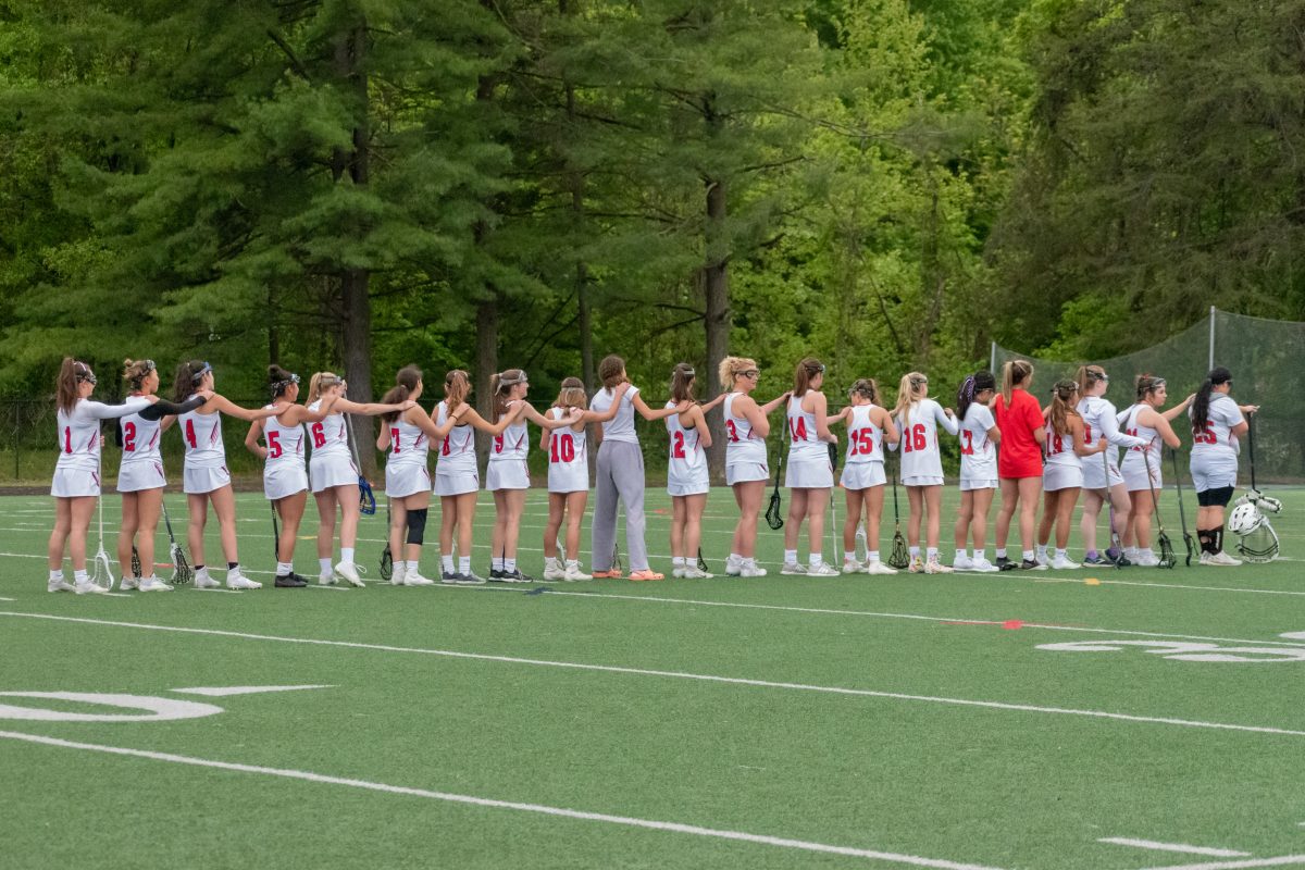 The girls lacrosse team lines up for the National Anthem ahead of last years game against Poolesville, which they won 9-6.