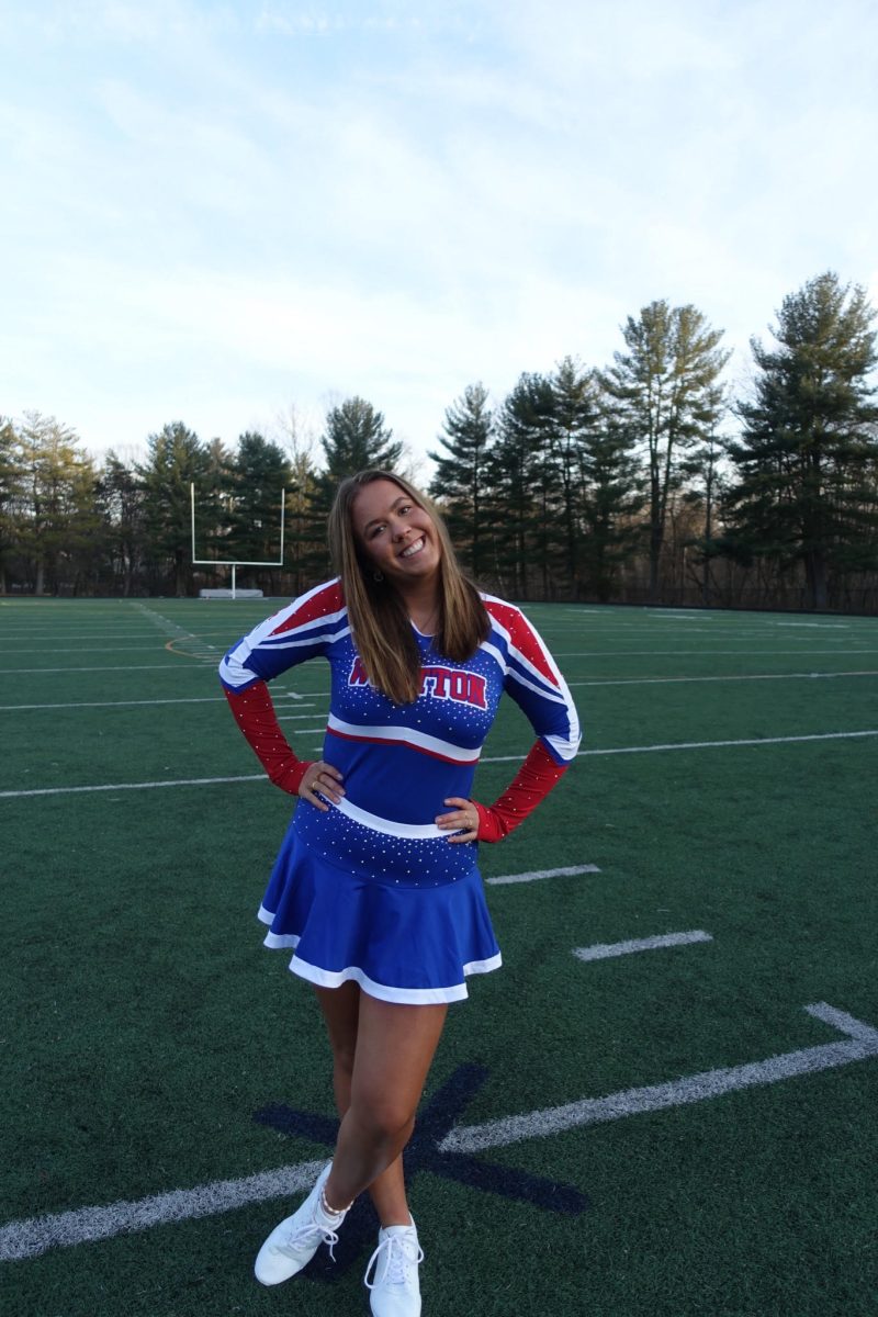 Junior Ebba Liese poses on the football field in her cheerleading uniform before cheer senior night. Since this is Lieses first and last season on the team she was able to participate in senior night. “Cheer is what I have always wanted to,” Liese said.