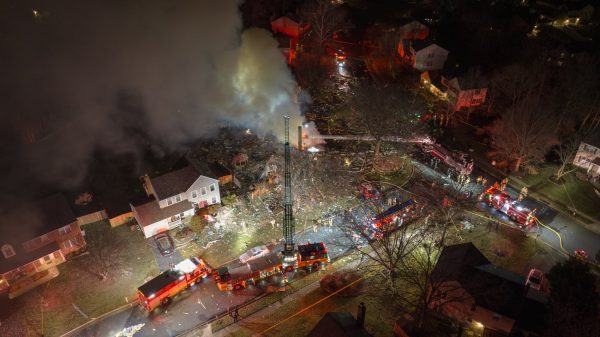 A house in Sterling, VA, exploded due to a gas leak from an underground propane tank, trapping 12 firefighters inside. One firefighter was killed, and 11 others and two civilians were injured.