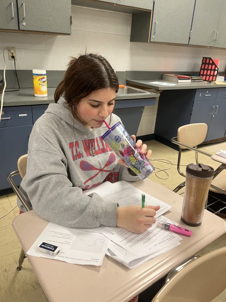 Sophomore Zoe Branco drinks two cups of coffee during lunch while completing her schoolwork.  On most days, Branco drinks coffee for an energy boost to get through the school day.