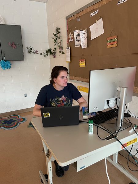New English teacher Sidney Wollmuth works at her computer preparing for students in between classes. 