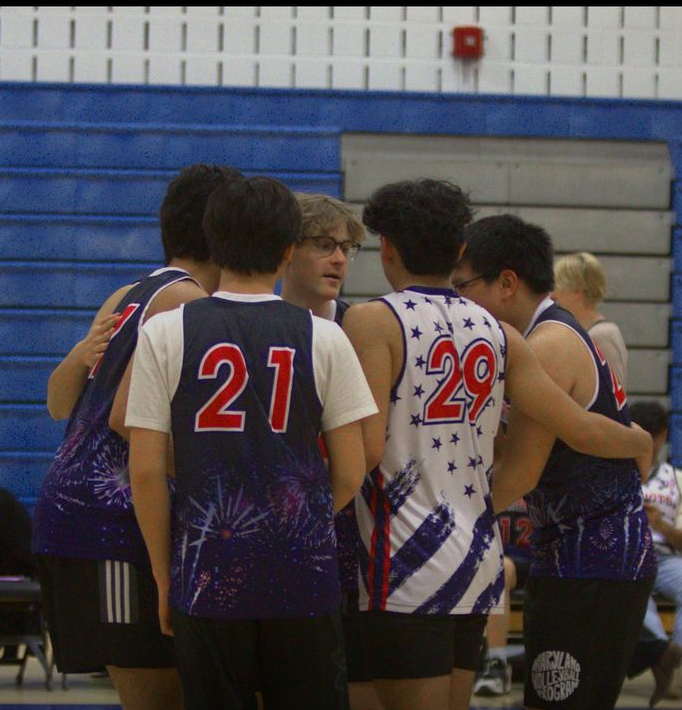 The+boys+varsity+volleyball+team+huddles+up+during+the+season+opener+against+Blake+on+Mar.+22.