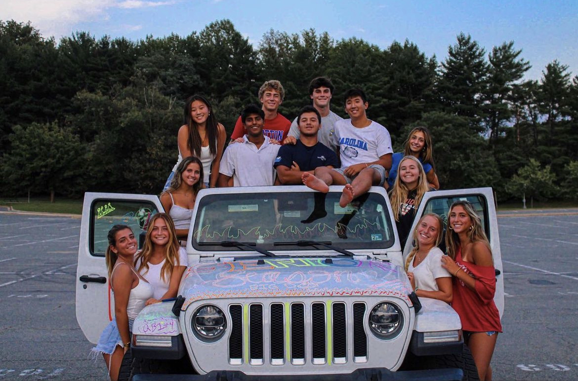 Despite not being allowed to paint their parking spots, seniors gather together before the school year begins to decorate their cars with washable paint. 