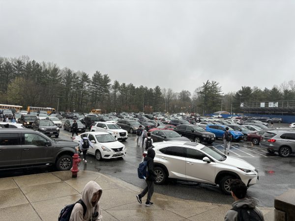 Students exit the school through the parking lot in the rain on Apr. 2.