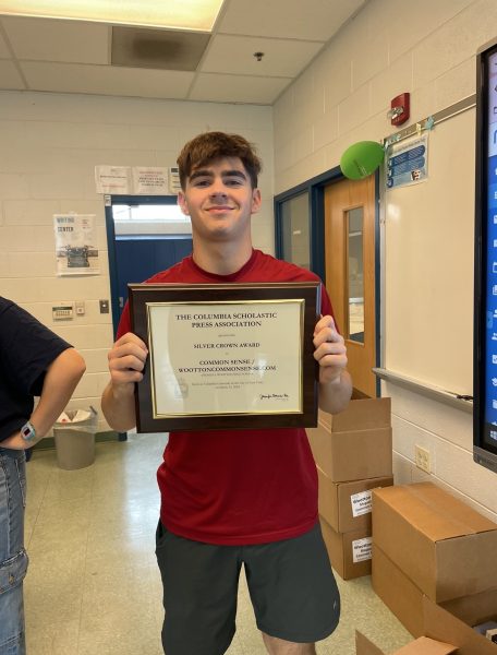 Junior Noah Friedman holds the Silver Crown Award given to Common Sense. Friedman won an individual CSPA first place award for an article under the General or Humor Commentary section.