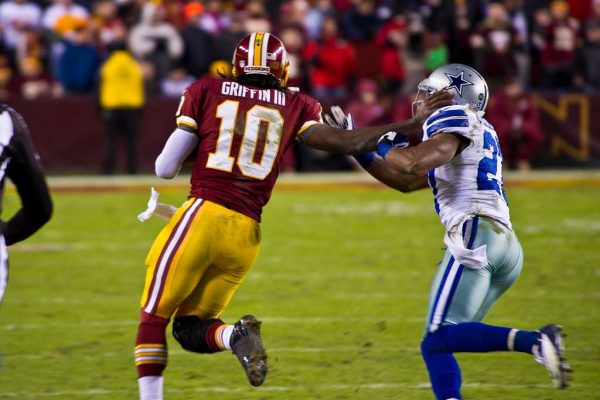 Former Commanders quarterback and second overall pick Robert Griffin III stiff-arms a Cowboys safety on Dec. 30, 2012.