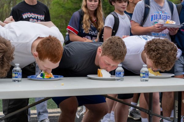 On Apr. 19 at the pep rally, senior Jai Gurewitz, sophomore Theo Gittleson and senior Sebastian Valdivia compete in the cake eating contest to see who can finish a slice first without the use of their hands.