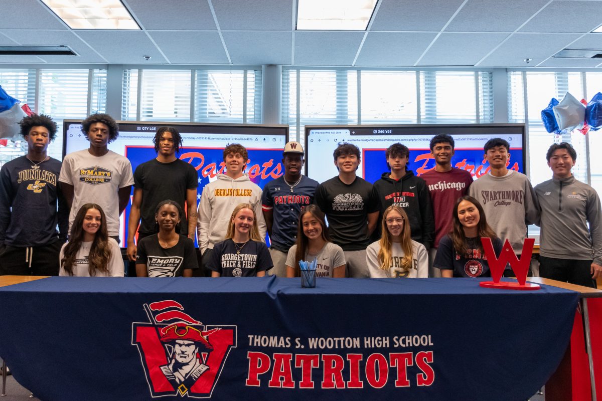 All 17 student athletes showcase their college merchandise as they officially signed onto their teams moments prior. They celebrated on Apr. 25 during lunch and advisory in the media center with family, friends, staff and coaches present.