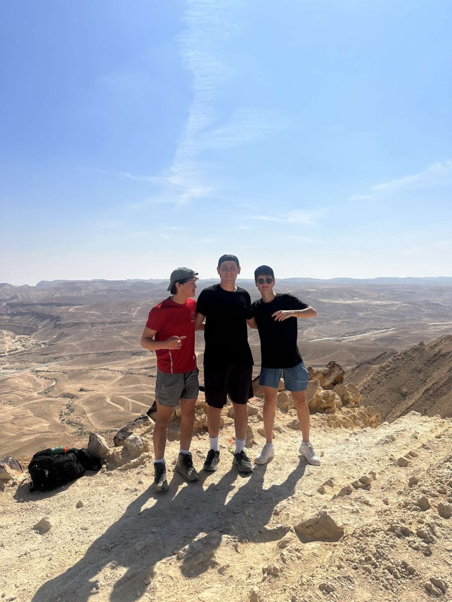 On Mar. 10 junior Ben Phillips (middle) and his roommates take a picture on a cliff hanging over the Israeli desert Negev.