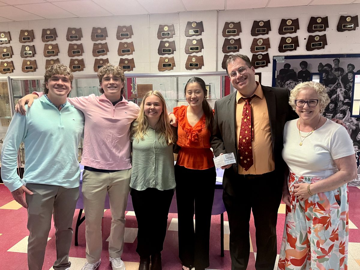Juniors Will and Charlie Balian, seniors Elizabeth Mehler and Kelly Ren, and AP Research teachers Brett Bentley and Michelle Hanson celebrate after the AP Research symposium on Apr. 25.