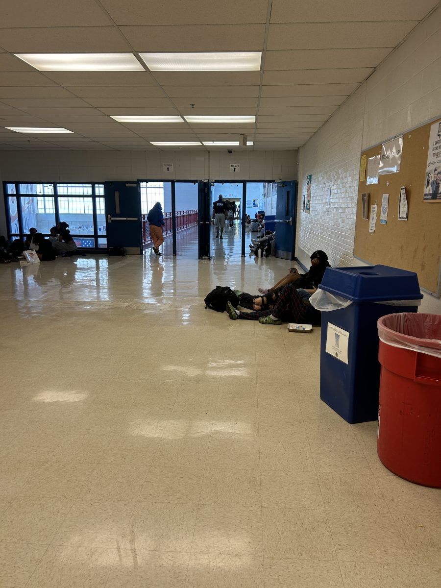 Students eat lunch in the hallway above the Commons, one of the most populated hallways in the school.