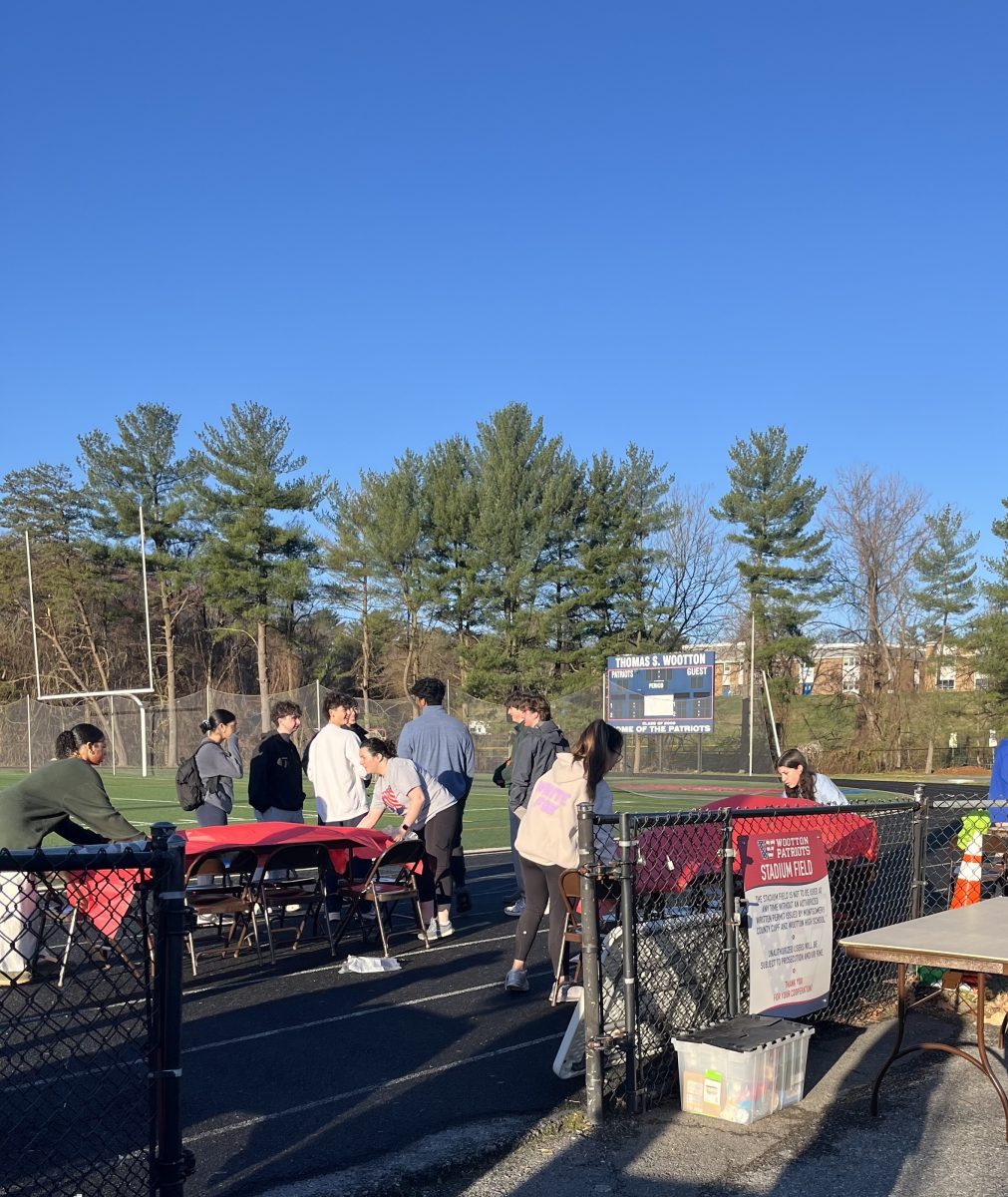 National Honor Society members help set up for the Sam Williams 5K on Mar. 16 for community hours. Community hours are much more reflective of your dedication to the society, junior Neil Kotval said.