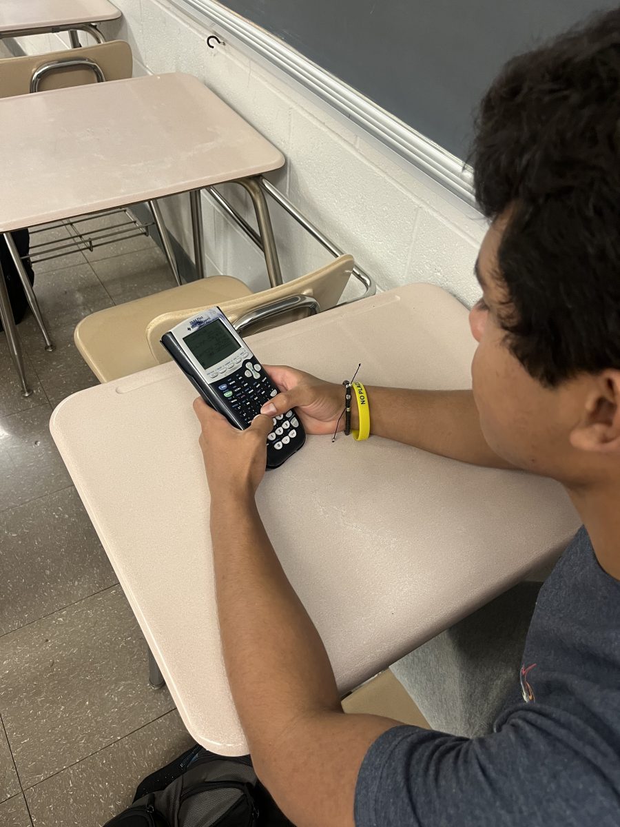 Junior Miguel Giron uses a calculator to solve a complex math problem. Calculators play a big role in high school math classes but some students argue that they still are not used enough.