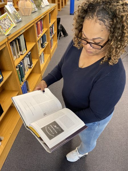 Media specialist Tammie Burk reads "Finding Justice: a History of Women Lawyers in Maryland since 1642," by Lynne A. Battaglia. "[Misinformation] is a huge problem today because people tend to trust everything they see on the internet and that information can be manipulated. One of the best ways to combat misinformation is to use sources that are trustworthy," Burke said.