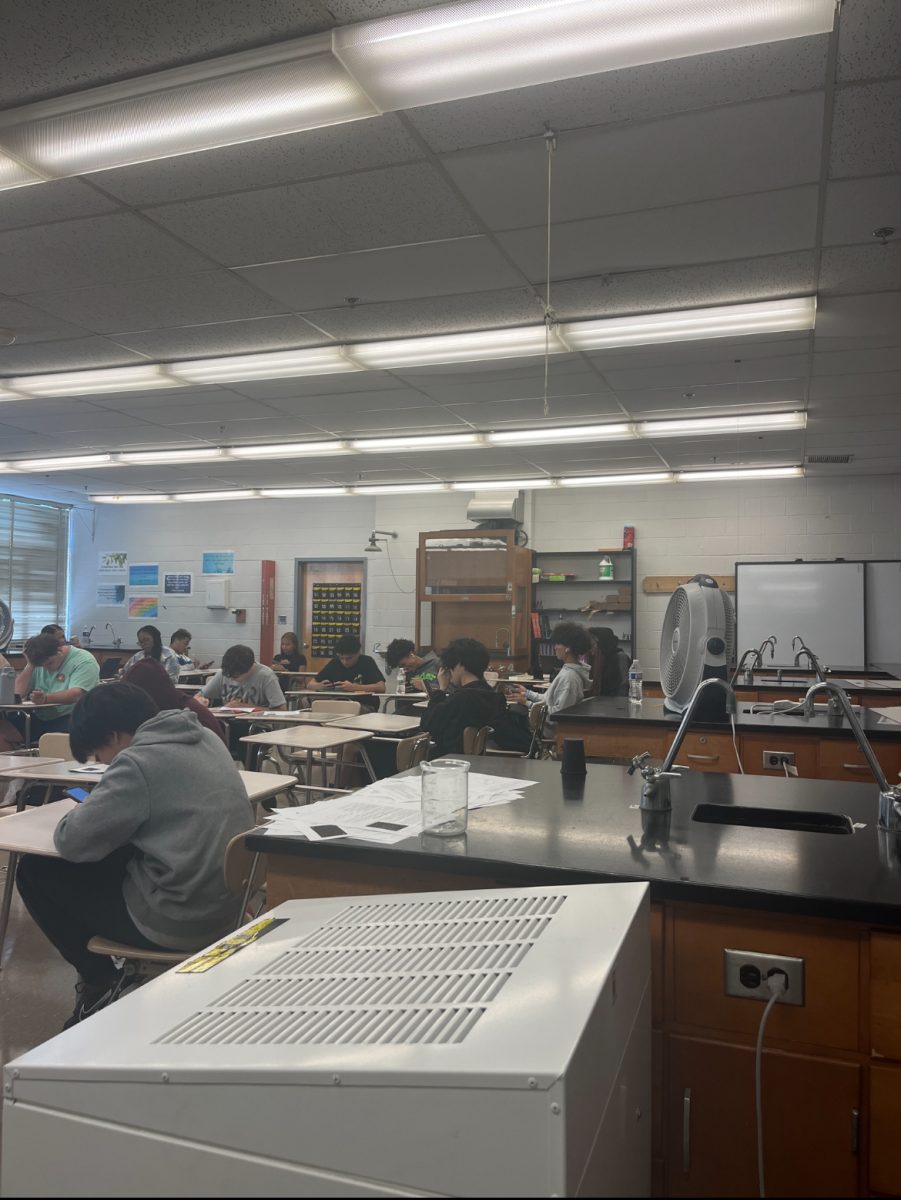 Physics teacher Kristen Schwarz's room,  209, doesn't have consistent air conditioning. Three fans work to keep students from overheating while doing their assignments.