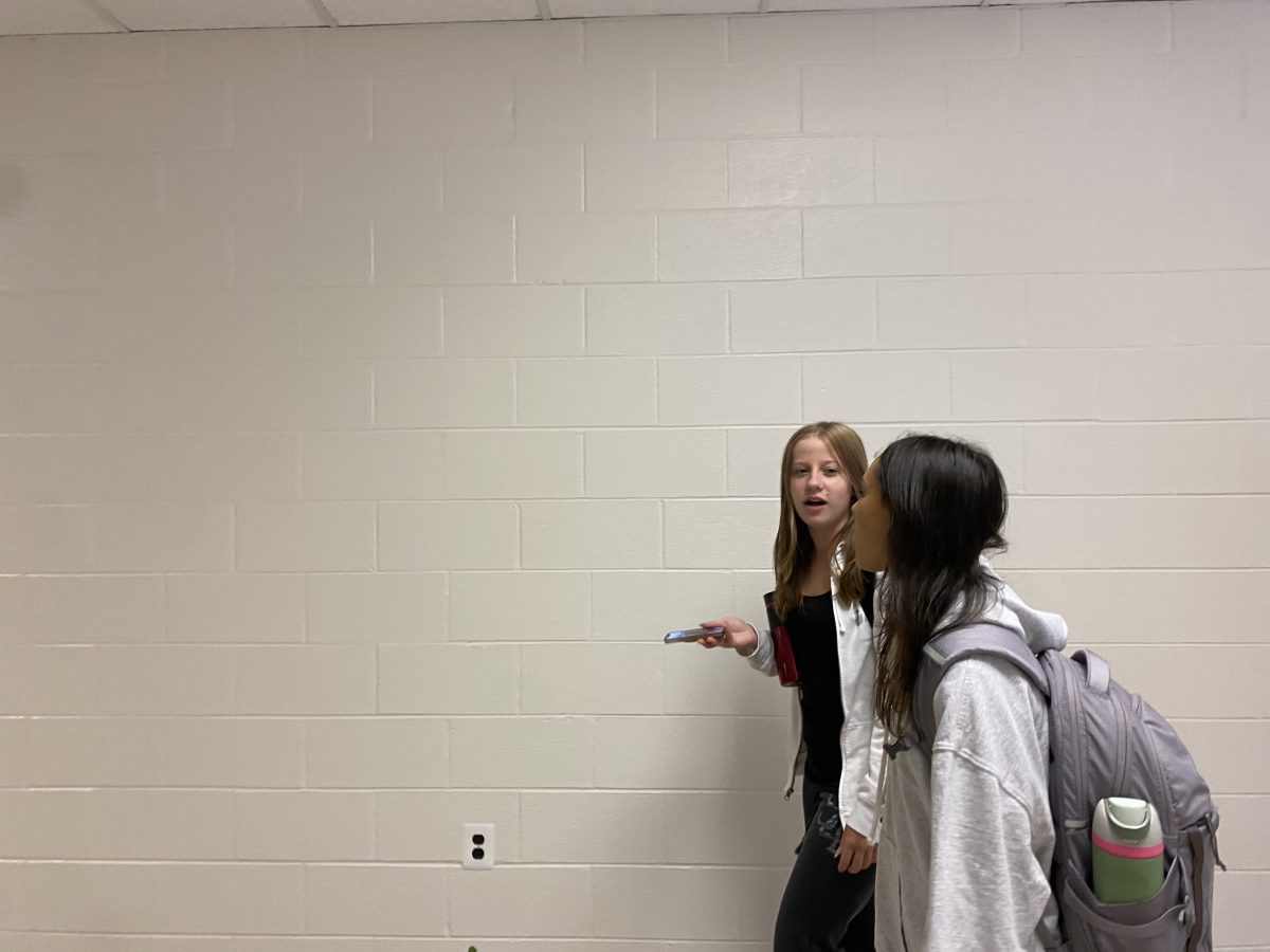 Senior' Maggie Hennessey and Mia Silbert walk past the painted over Best Buddies wall. "My sister's handprint was on this wall and it was nice to see from time to time, but it's gone now," Hennessy said.