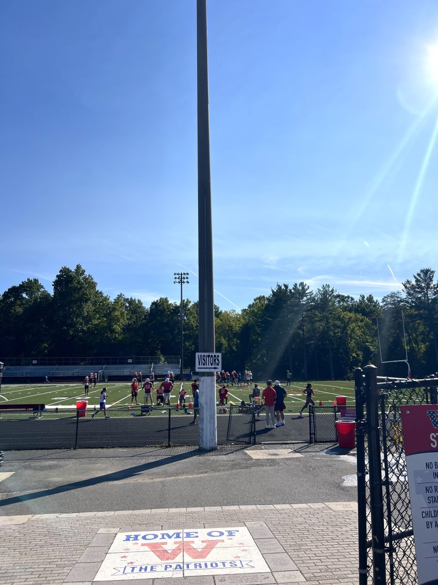 The JV football team practices on the new field after school on Sept. 12. The new turf is softer and more cooling, according to Athletic Director Al Lightsey.