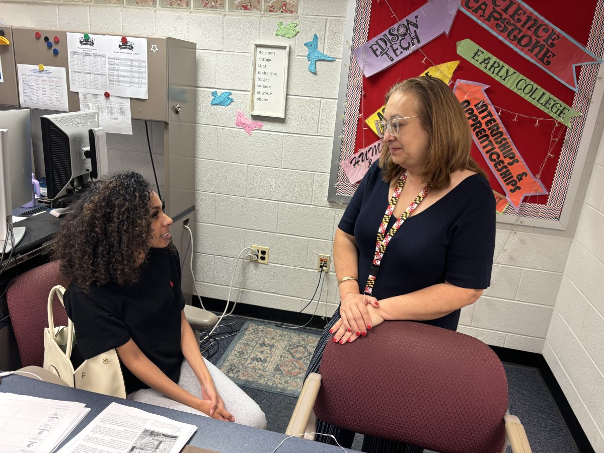 Senior Hanan Alsaghir consults College and Career Information Coordinator Jennifer Macdonald on Friday, Sep. 13 about her college list. Macdonald said, "We actually have more information about a guest speaker from Montgomery College coming out soon." Macdonald sent out an email later that day about an after-school workshop on Sep. 27 at which students can have their college essays read by school staff or industry experts and a representative from Montgomery College will give a presentation.