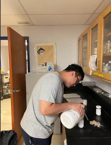 Former AP Chemistry student and intern Ayush Garg measures out salt for AP Chemistry class during fourth period. "I want to improve the experience for other AP Chem students," Garg said.