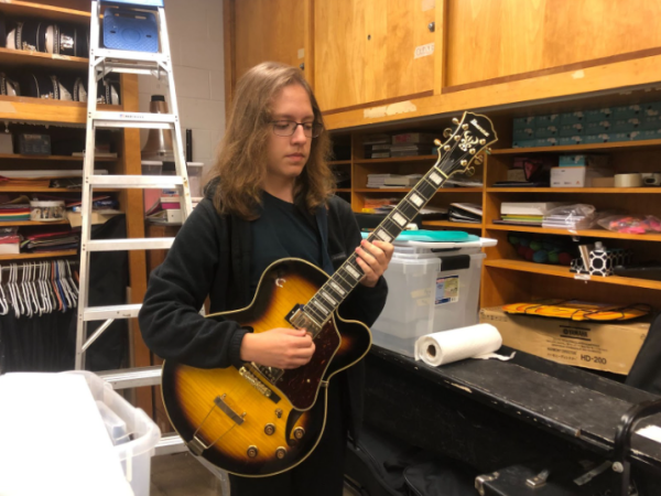 Sophomore Gleb Godynskiy rehearses a piece on the electric guitar two days before the upcoming performance at the football game. Godynskiy previously played the guitar for fun and took the opportunity to join the marching band this year to improve his skills. “It’s very nice to be able to play guitar in marching band. I think it’s a very unique experience that not a lot of people can attest to,” Godynskiy said.