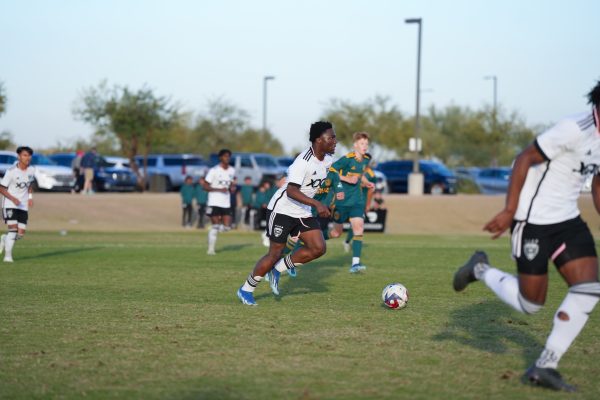 Junior Langston Fabiyi dribbles the ball down the field during his game for D.C. United Academy. "When I see a scout I definitely feel more pressure to play well," Fabiyi said.