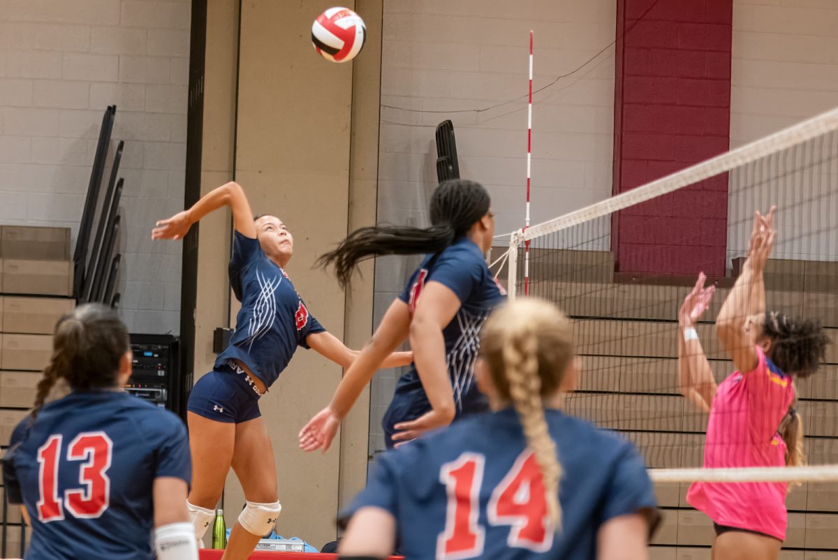 Senior Naima Cho-Khaliq winds up for a kill during the girls' varsity volleyball match where they defeated Bethesda-Chevy Chase 3-0 at their first home game of the season on Sept. 10, adding the first point to the school's score in the County Cup competition.