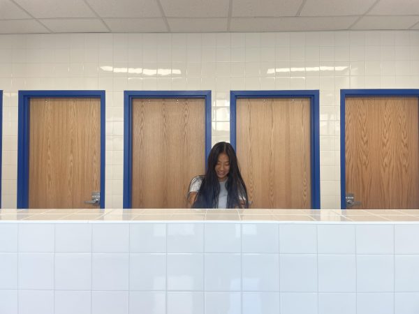 Senior Emma Yuan washes her hands after testing out the new bathrooms. "I don't really like the bathrooms because I like having a private space where I can wash my hands and freshen up in the mirror," Yuan said.